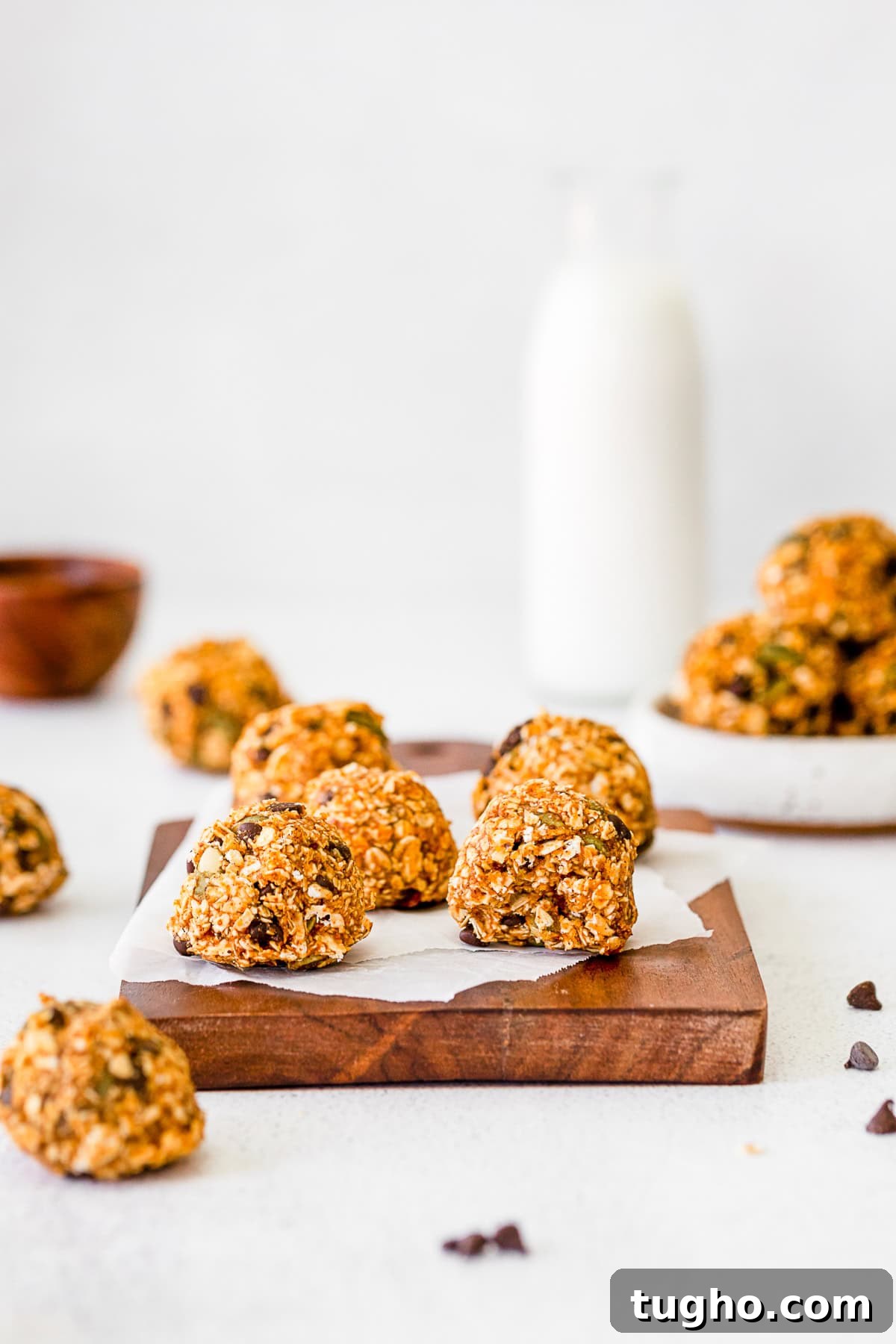 Pumpkin Energy Balls on a table with a bite taken out of it.