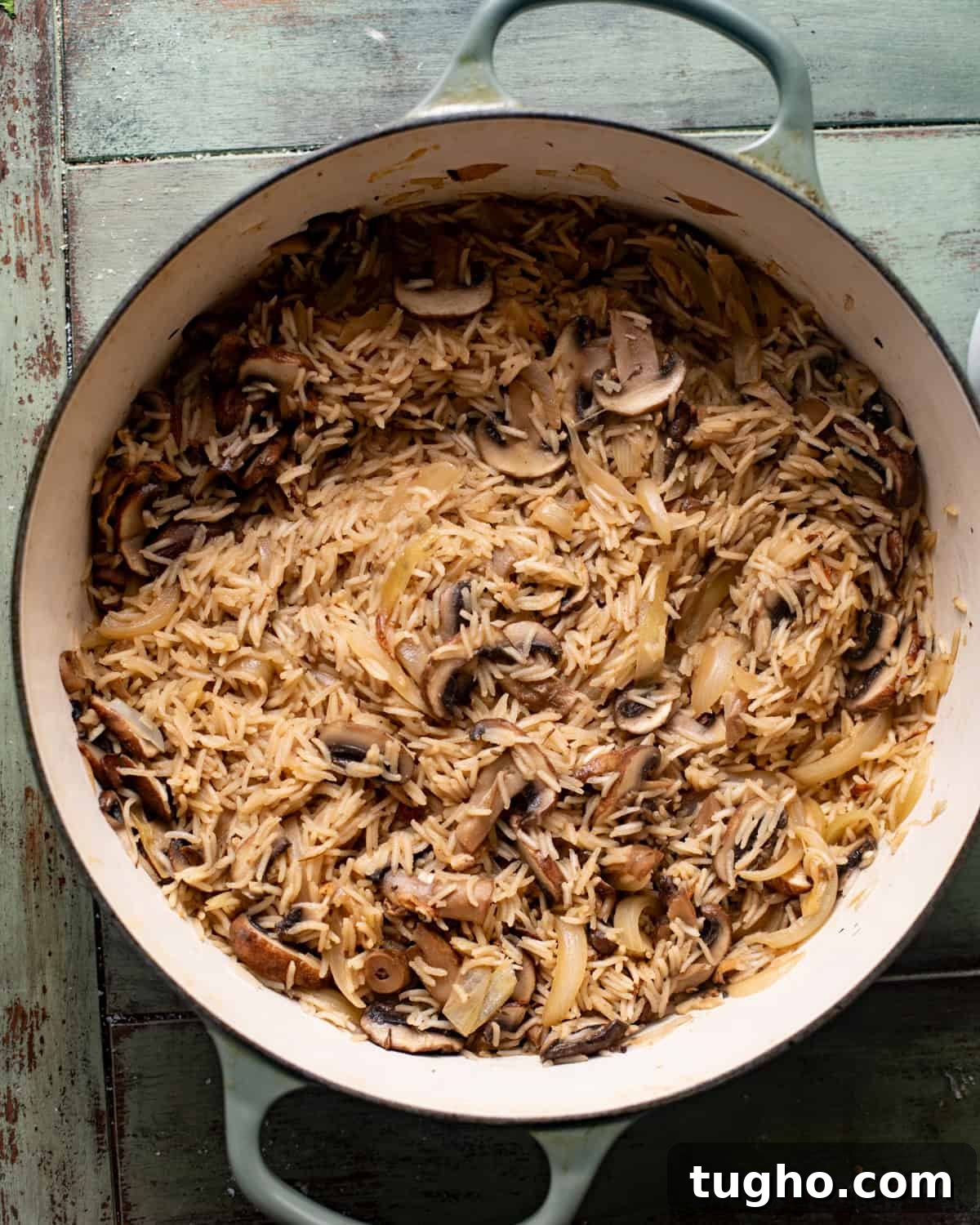 Creamy Chicken and Rice with Mushrooms 6 mushrooms, onions, garlic, seasonings, and rice in a pan with wine and chicken broth.