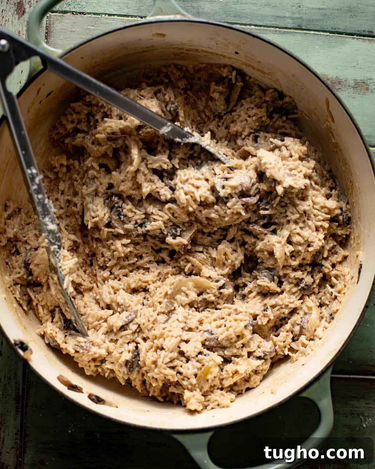 Creamy Chicken and Rice with Mushrooms 7 cooked rice in a pot with cream and parmesan cheese.