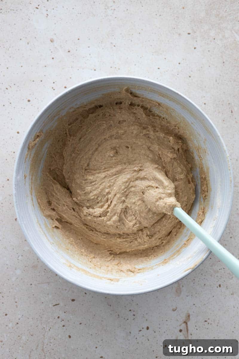 Homemade Baked Cinnamon Sugar Donuts Recipe 6 Wet and dry ingredients combined together in a large bowl with a spatula.