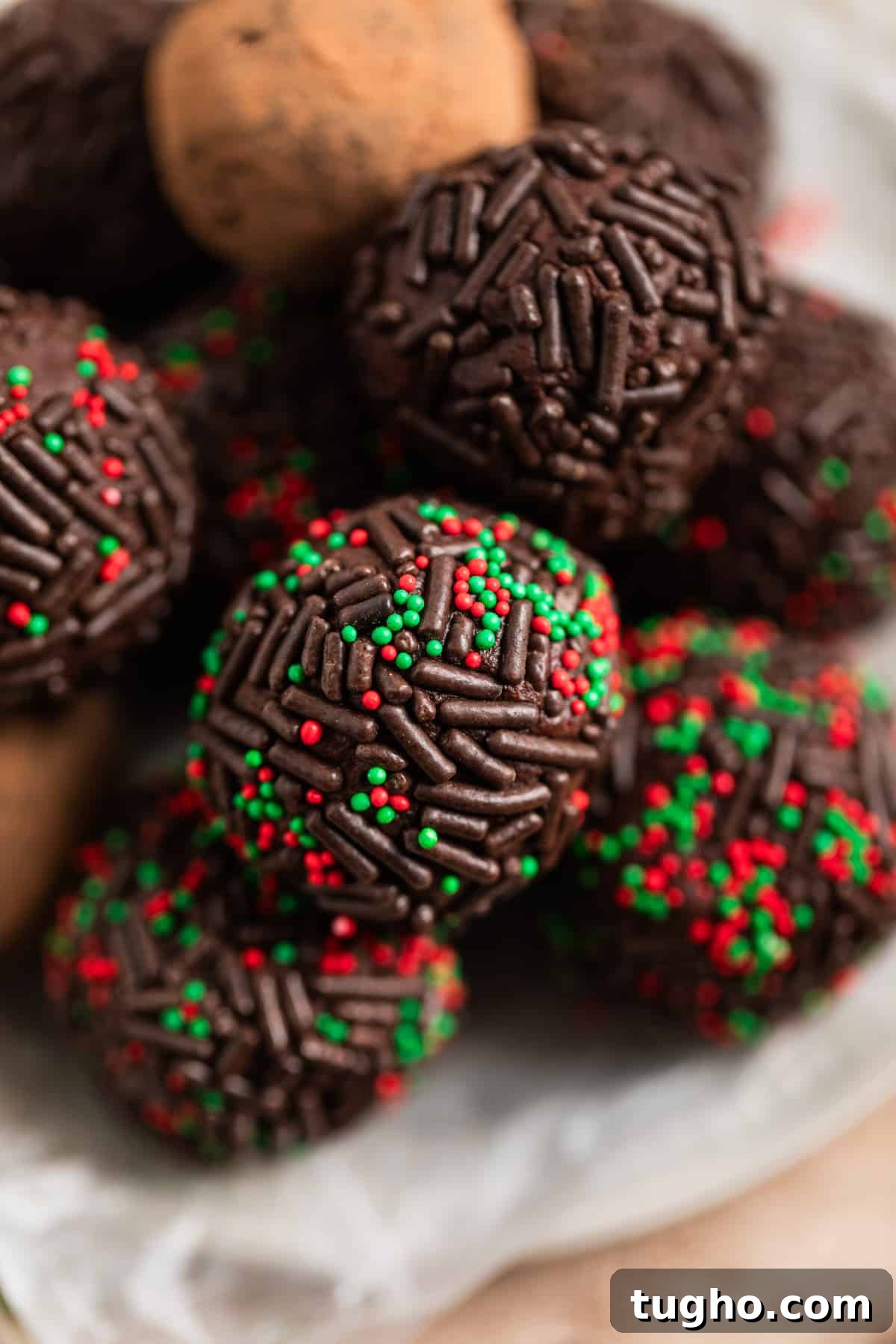 Overhead view of amaretto truffles coated in sprinkles on dish.