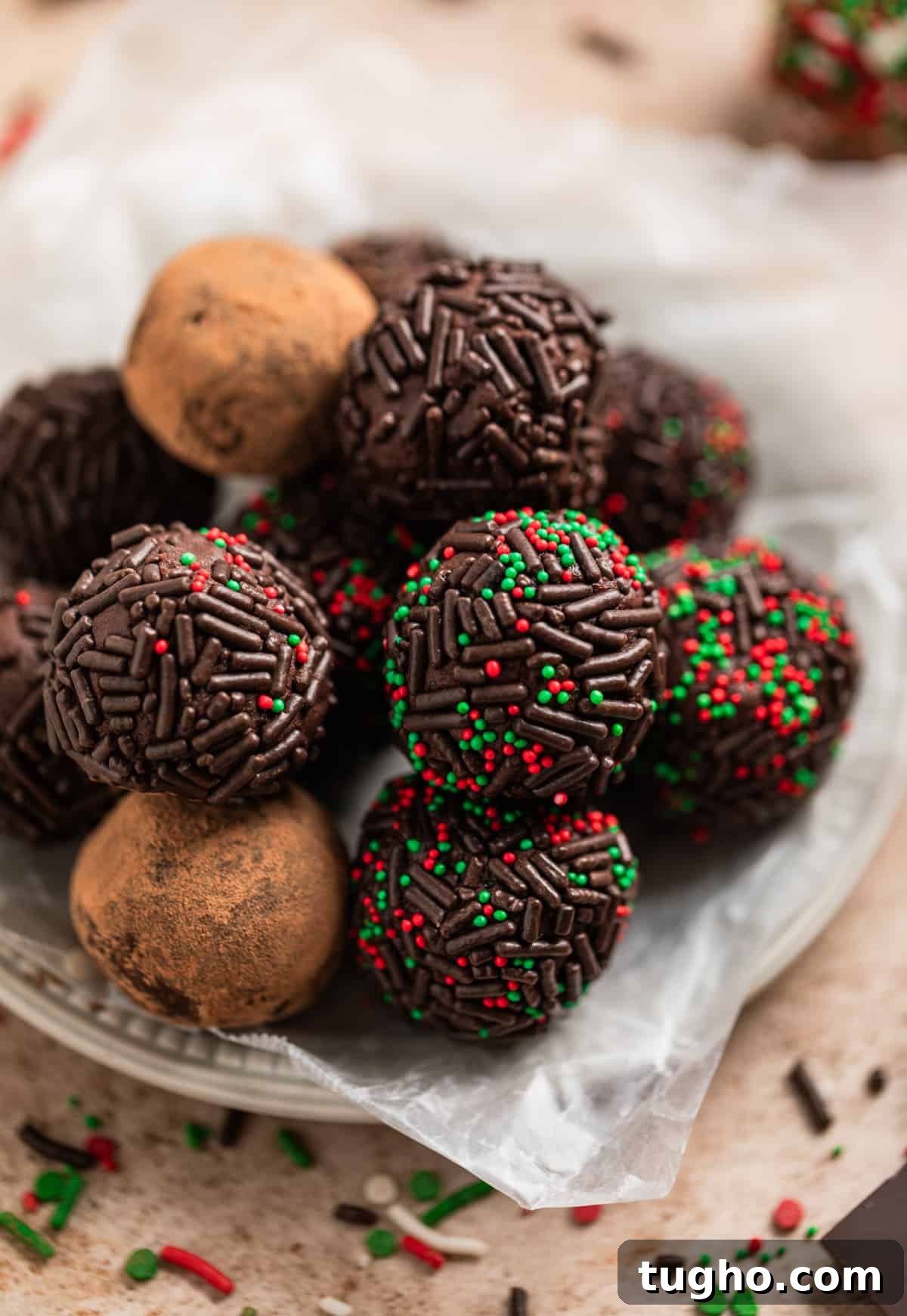 Tray with variety of cocoa dusted and sprinkle covered chocolate truffles.