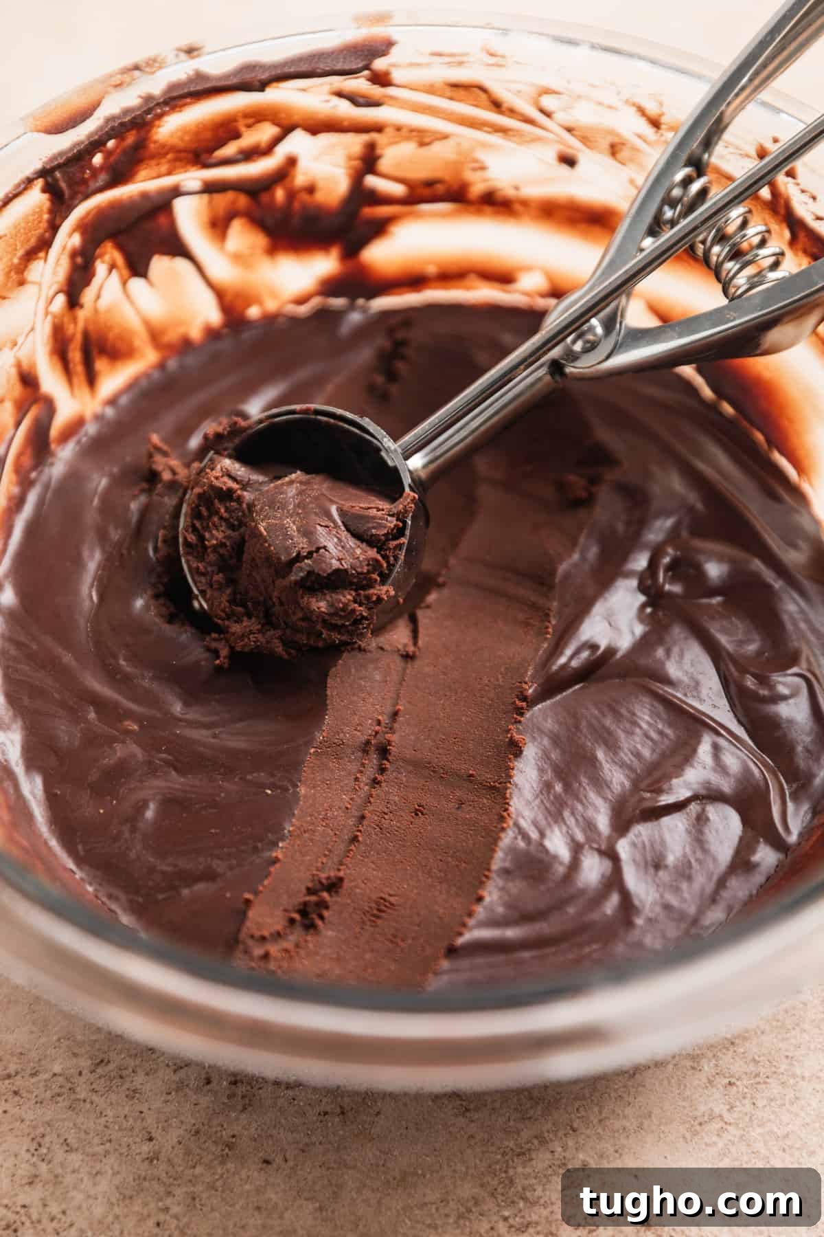 Cookie scoop with chocolate truffle mixture scooped.