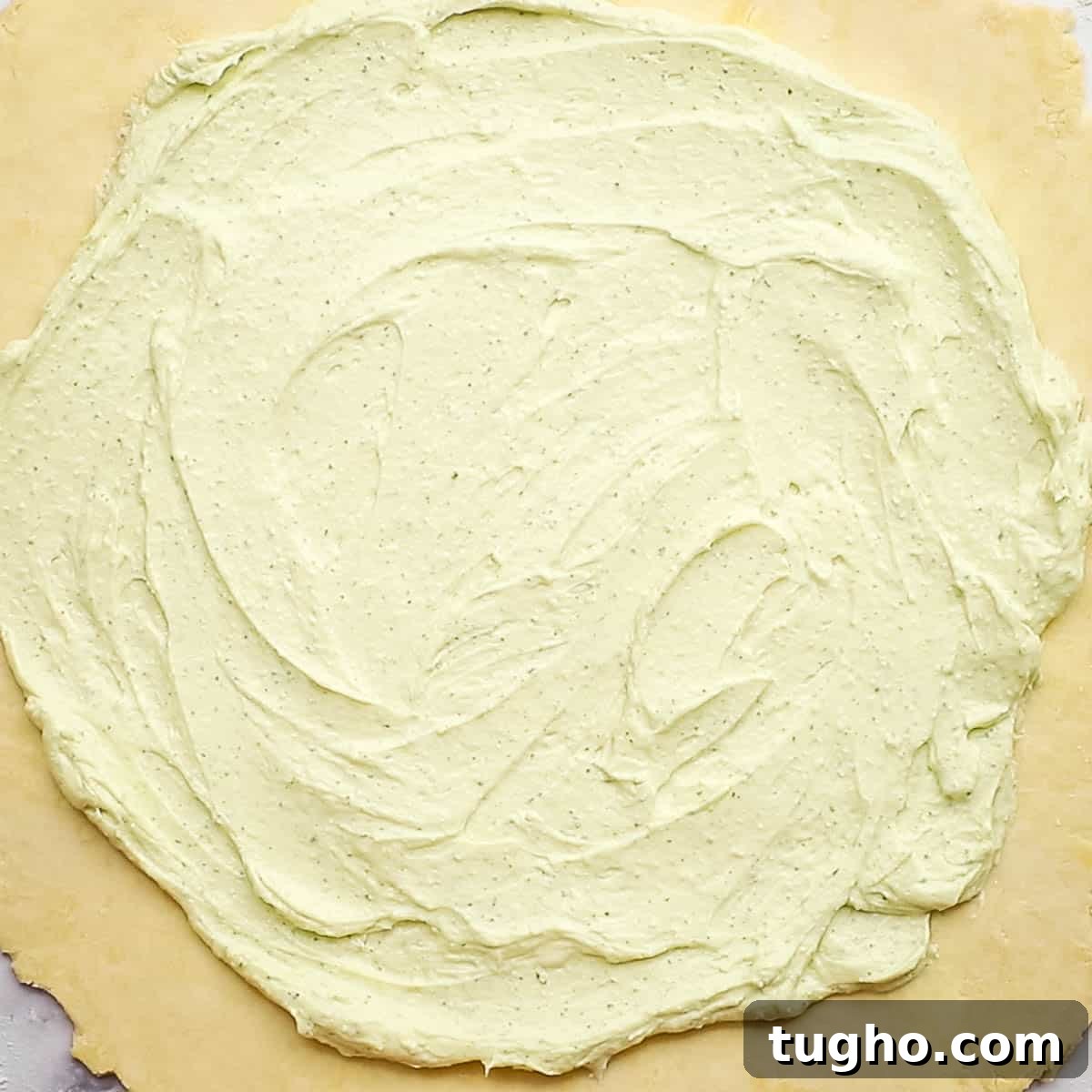 whipped feta spread out on the dough