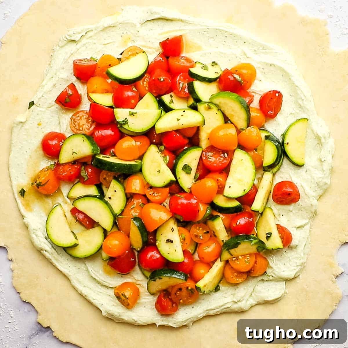 spreading out vegetables on the whipped out feta mixture