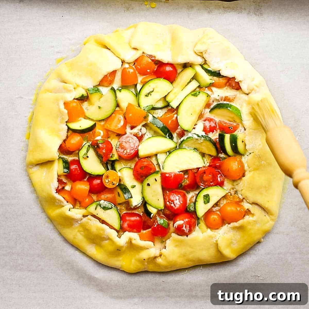 brushing egg wash on the exposed pie crust