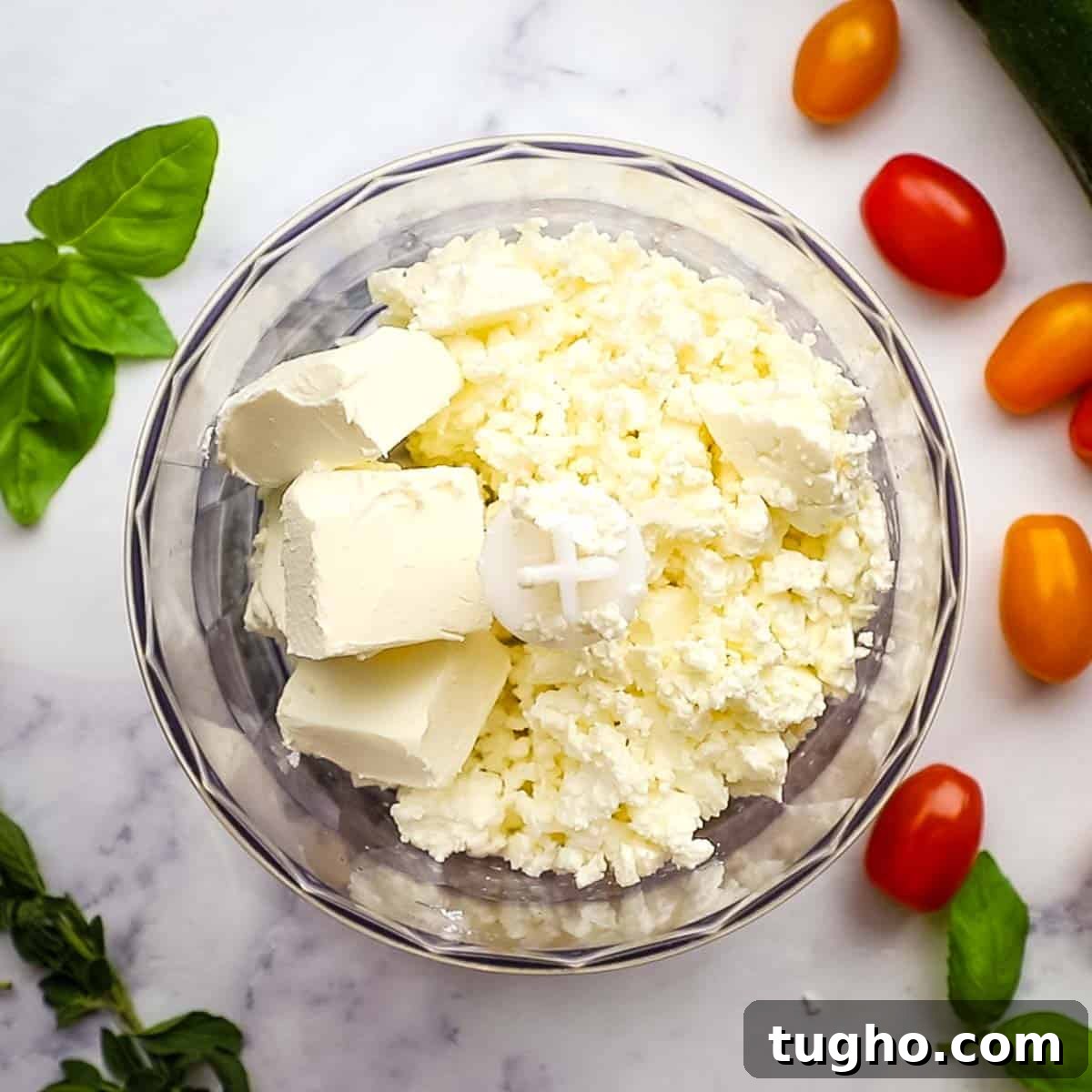pulsing together the feta and cream cheese in a food processor