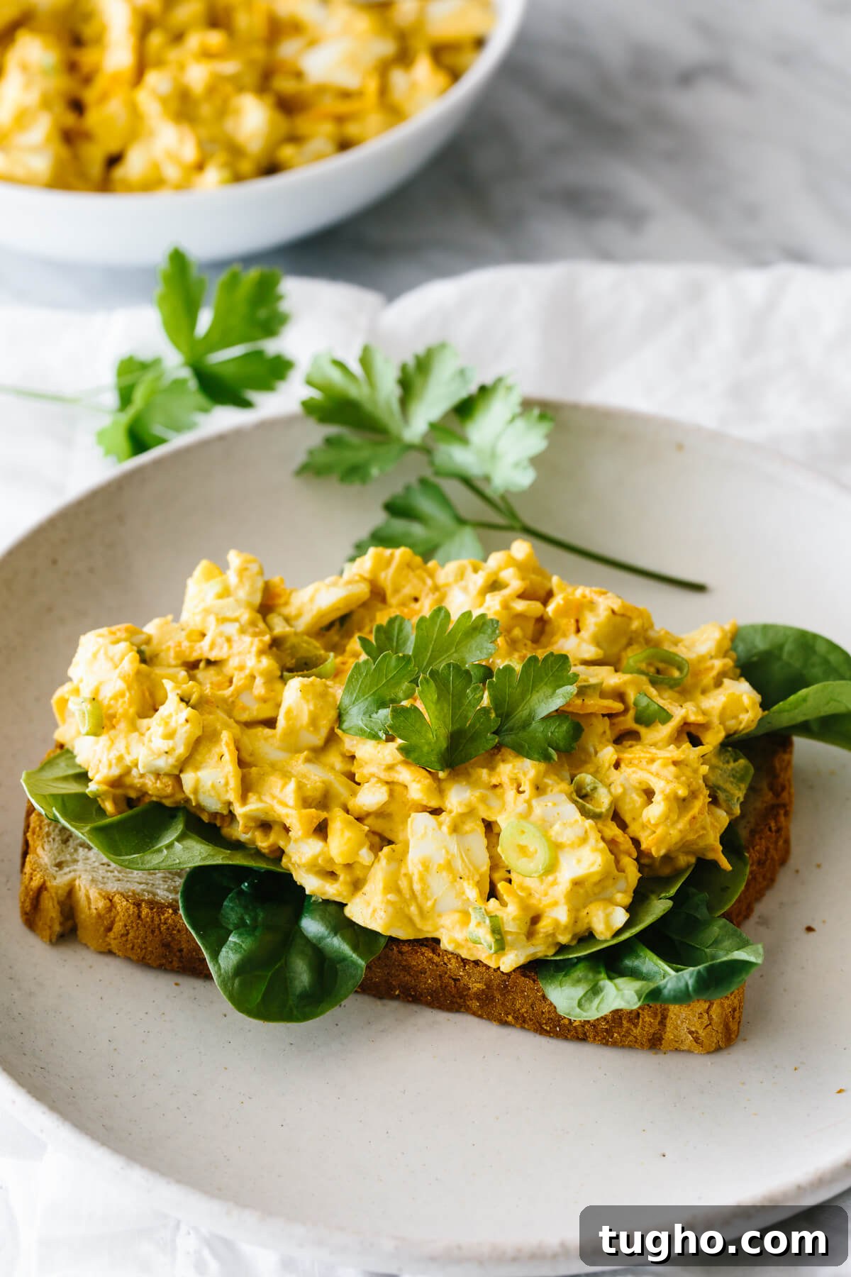 40+ Fresh and Flavorful Salad Recipes 10 Curried egg salad on top of spinach and bread makes an open faced sandwich.