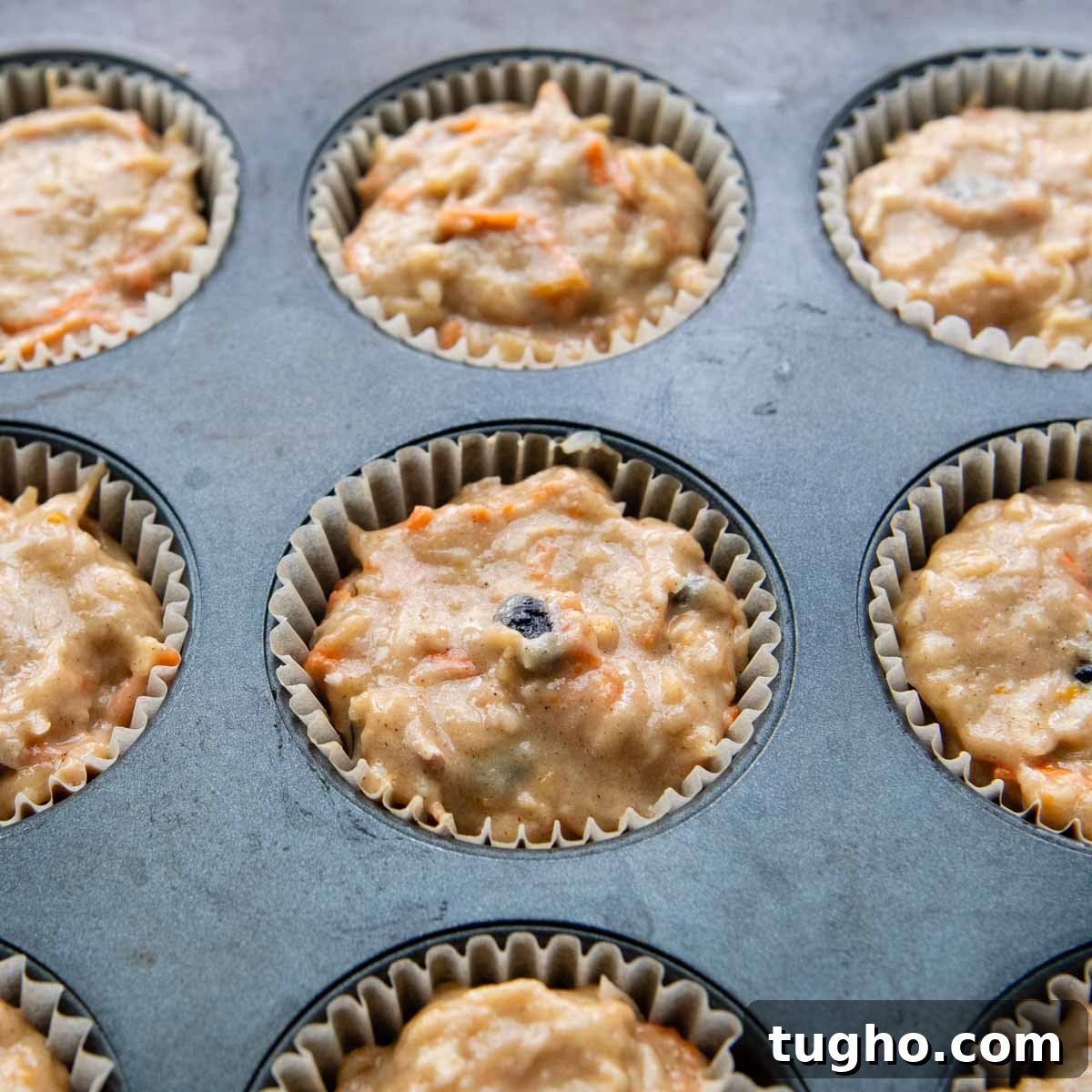 Gluten-Free Morning Glory Muffins: Moist One-Bowl Recipe 6 a muffin tin with filled with unbaked batter.