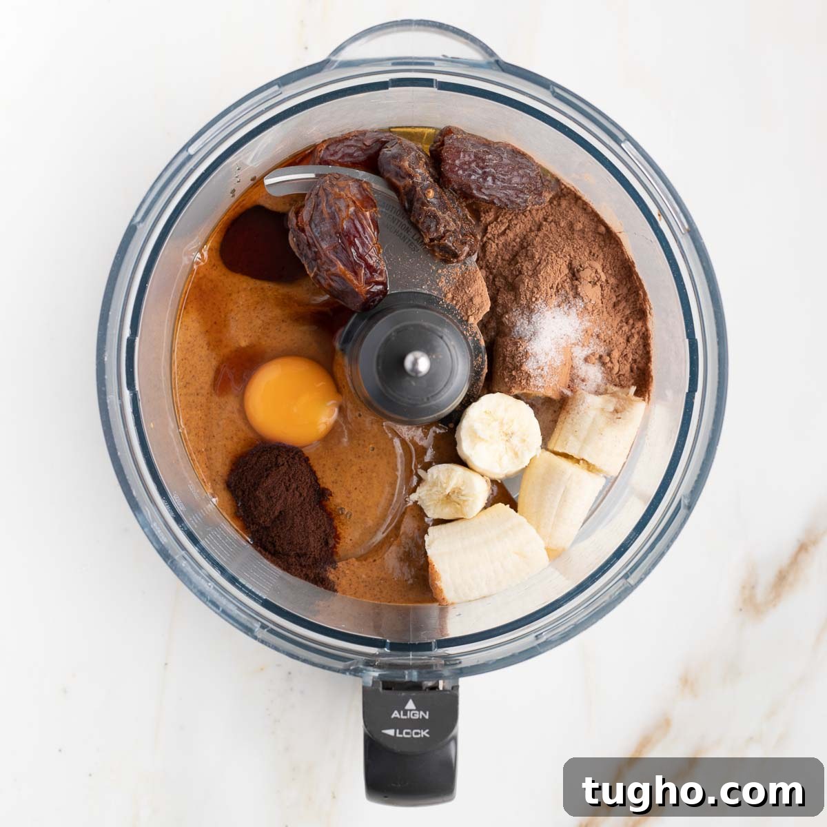 Fudgy Double Chocolate Zucchini Muffins Recipe 6 Ingredients in a food processor bowl: banana, egg, cocoa powder, dates.