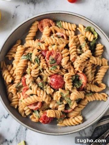 Plate of Hummus Pasta w/ grape tomatoes and spinach