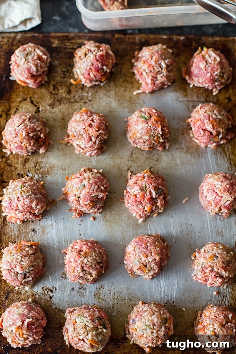 Porcupine Meatballs (Tefteli) in Creamy Tomato Sauce Recipe 4 raw meatballs on a cookie sheet