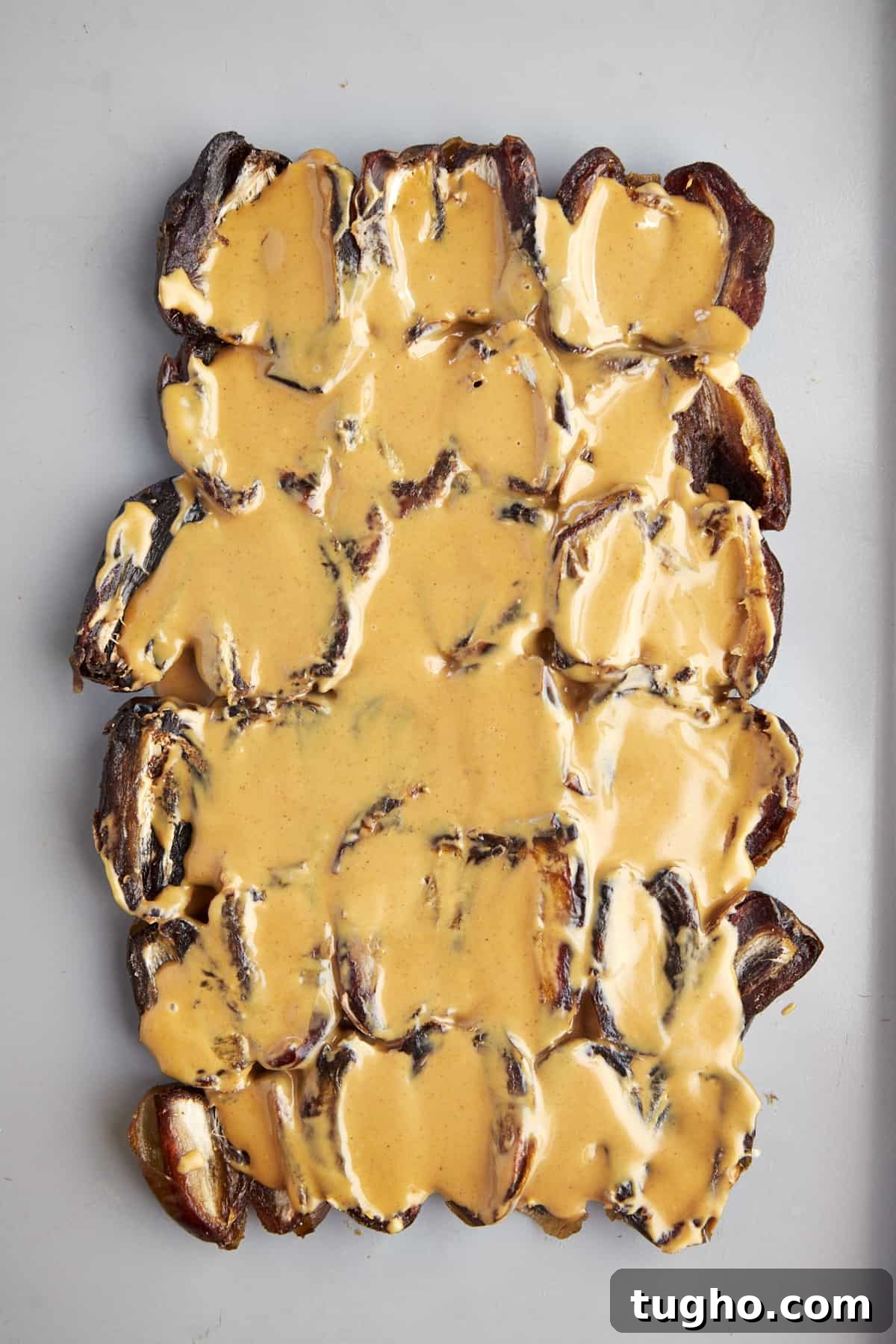 Viral TikTok Date Bark Recipe: Chocolate and Nuts 3 A layer of split dates topped with peanut butter.
