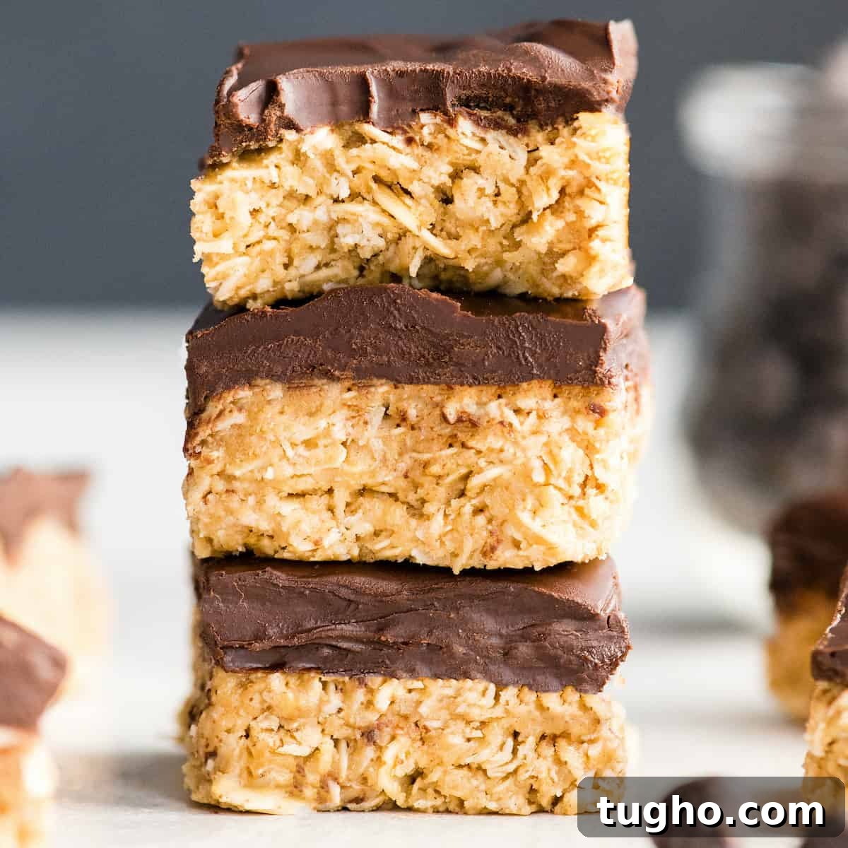 Chewy No-Bake Oatmeal Bars Recipe 2 a stack of 3 No Bake Oatmeal Bars, the top one with a bite taken out of it