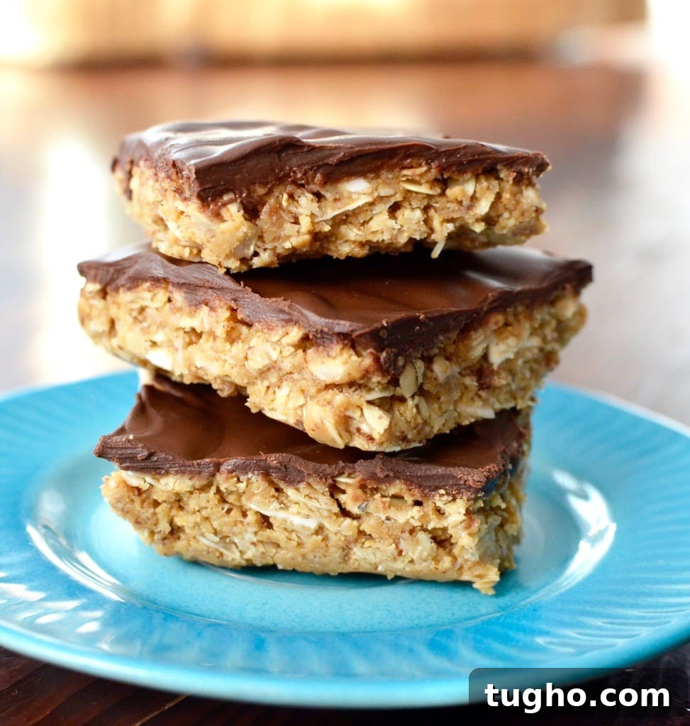 Chewy No-Bake Oatmeal Bars Recipe 14 Front view of a stack of three Chocolate Peanut Butter Coconut Bars on a plate