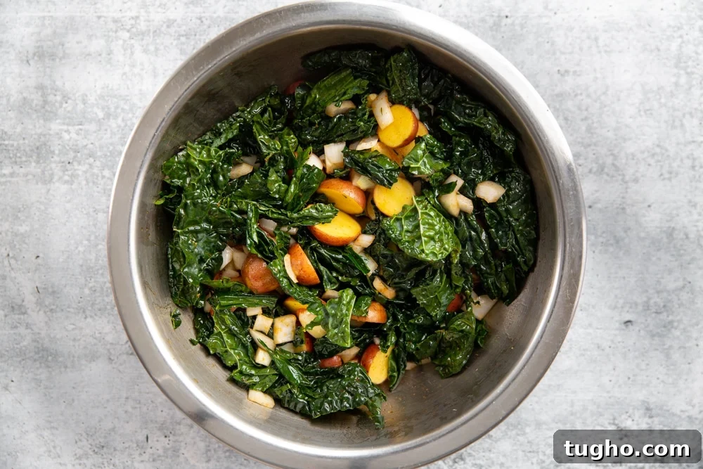 Crispy Sheet Pan Roasted Chicken with Vegetables 5 Kale, potatoes, onion, garlic and thyme in a large mixing bowl.