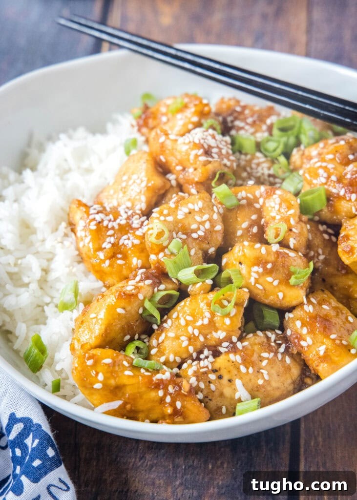 white bowl with bourbon chicken and rice