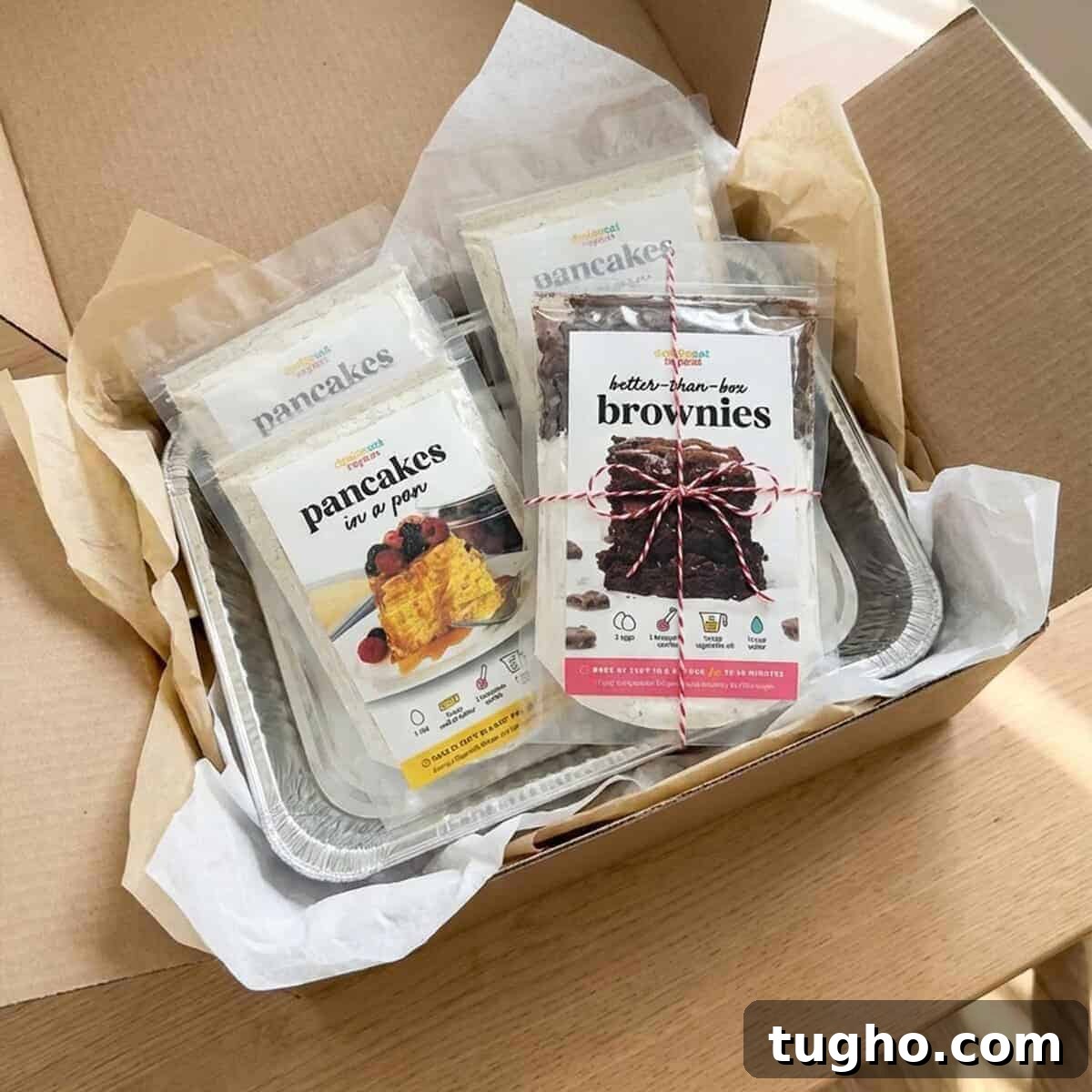 Homemade Brownie Mix Recipe for Gifts 12 Brownie mix gift packaged in a care package box for shipping, surrounded by baking supplies
