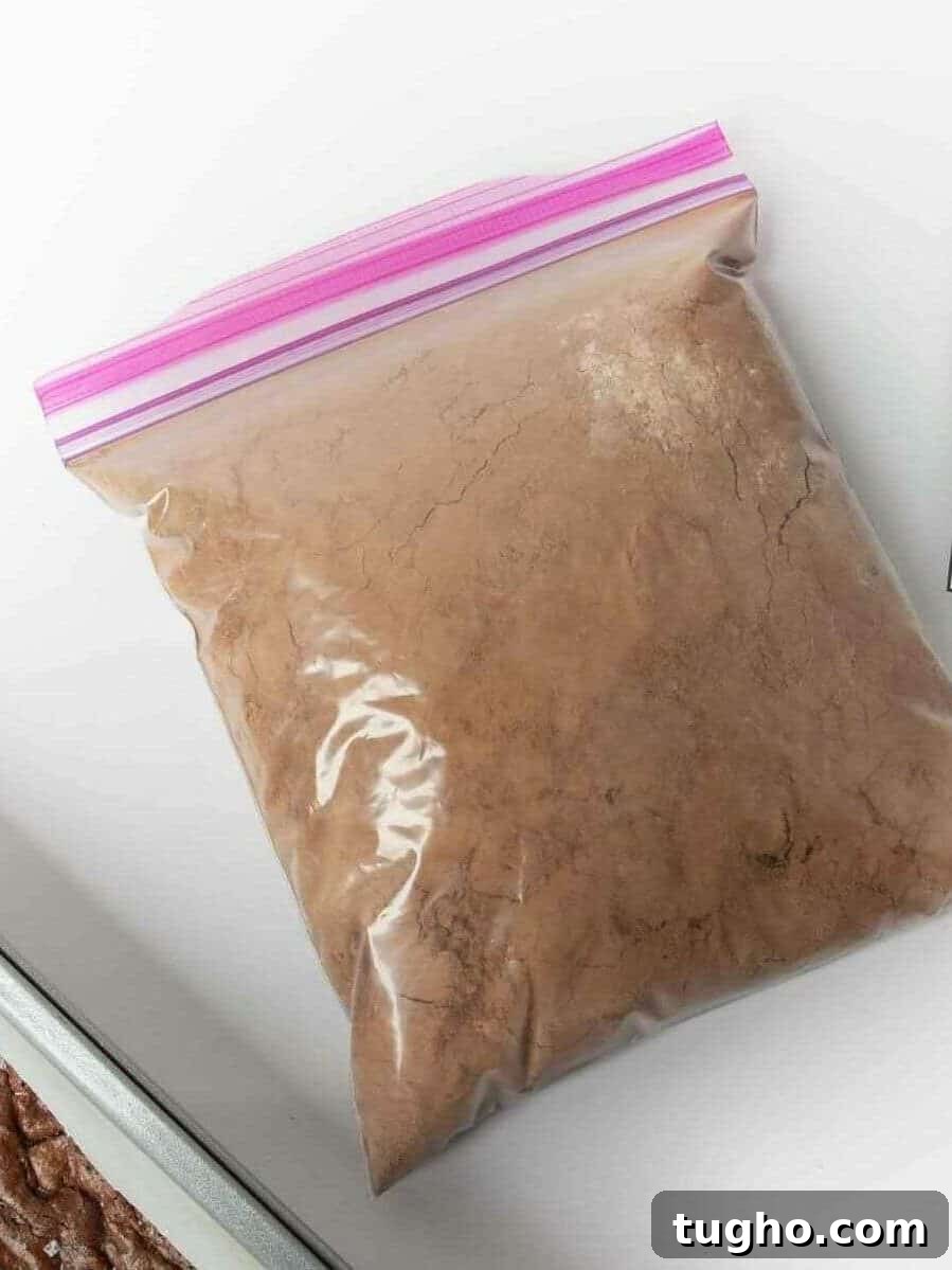 Homemade Brownie Mix Recipe for Gifts 8 Sealed bag of homemade brownie mix with a printed label showing baking instructions, next to a pan of baked brownies