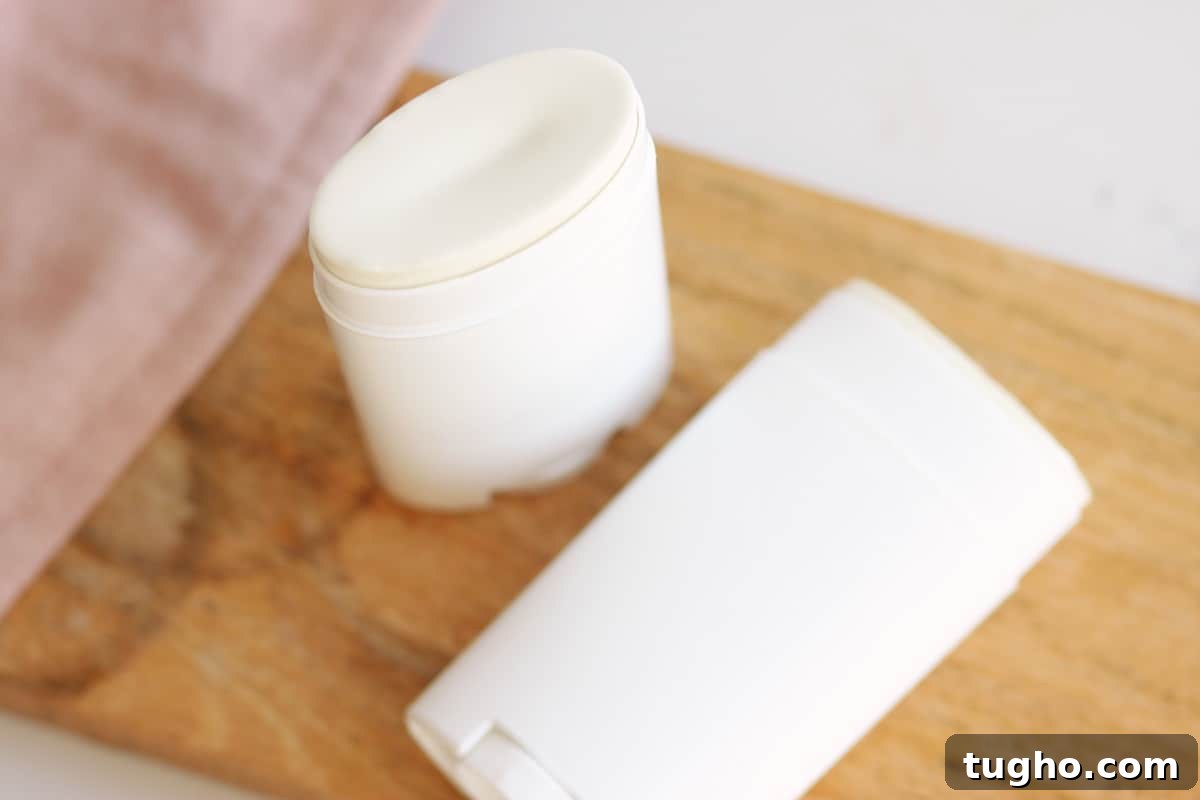 two unused tubes of homemade deodorant laying on a countertop