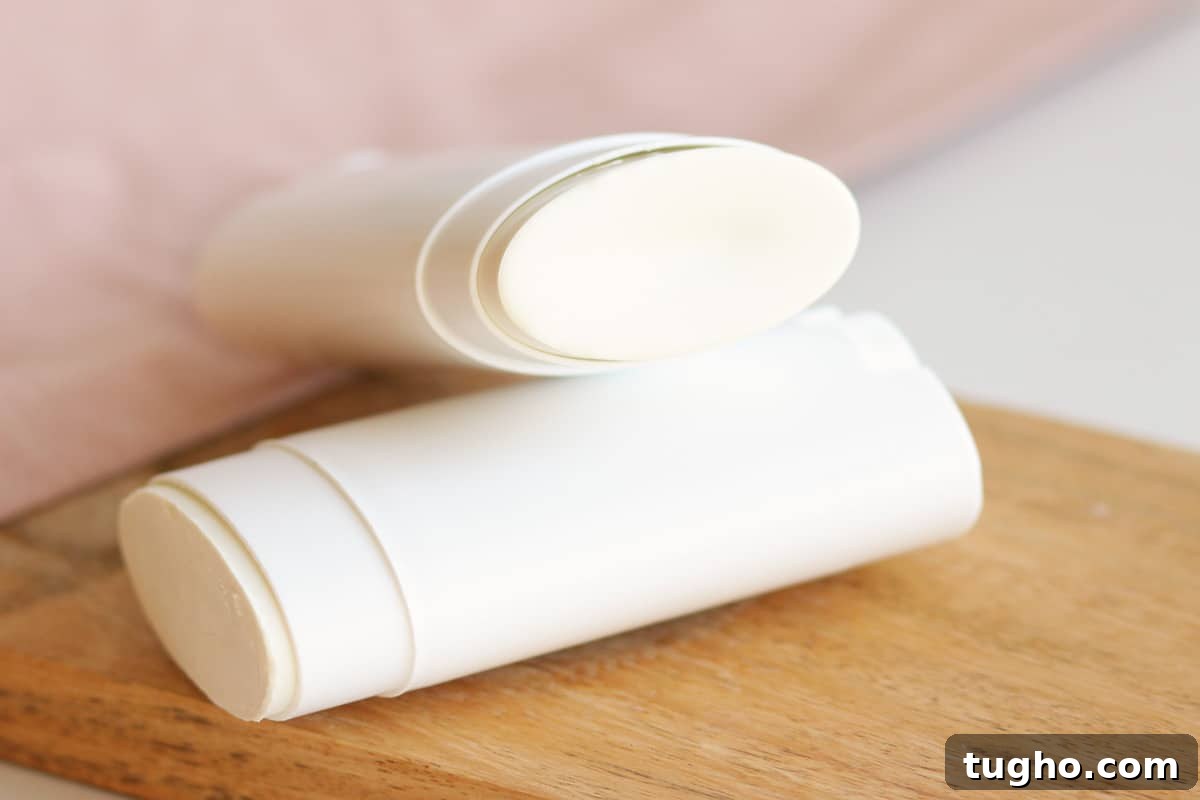 two unused tubes of homemade deodorant laying on a countertop