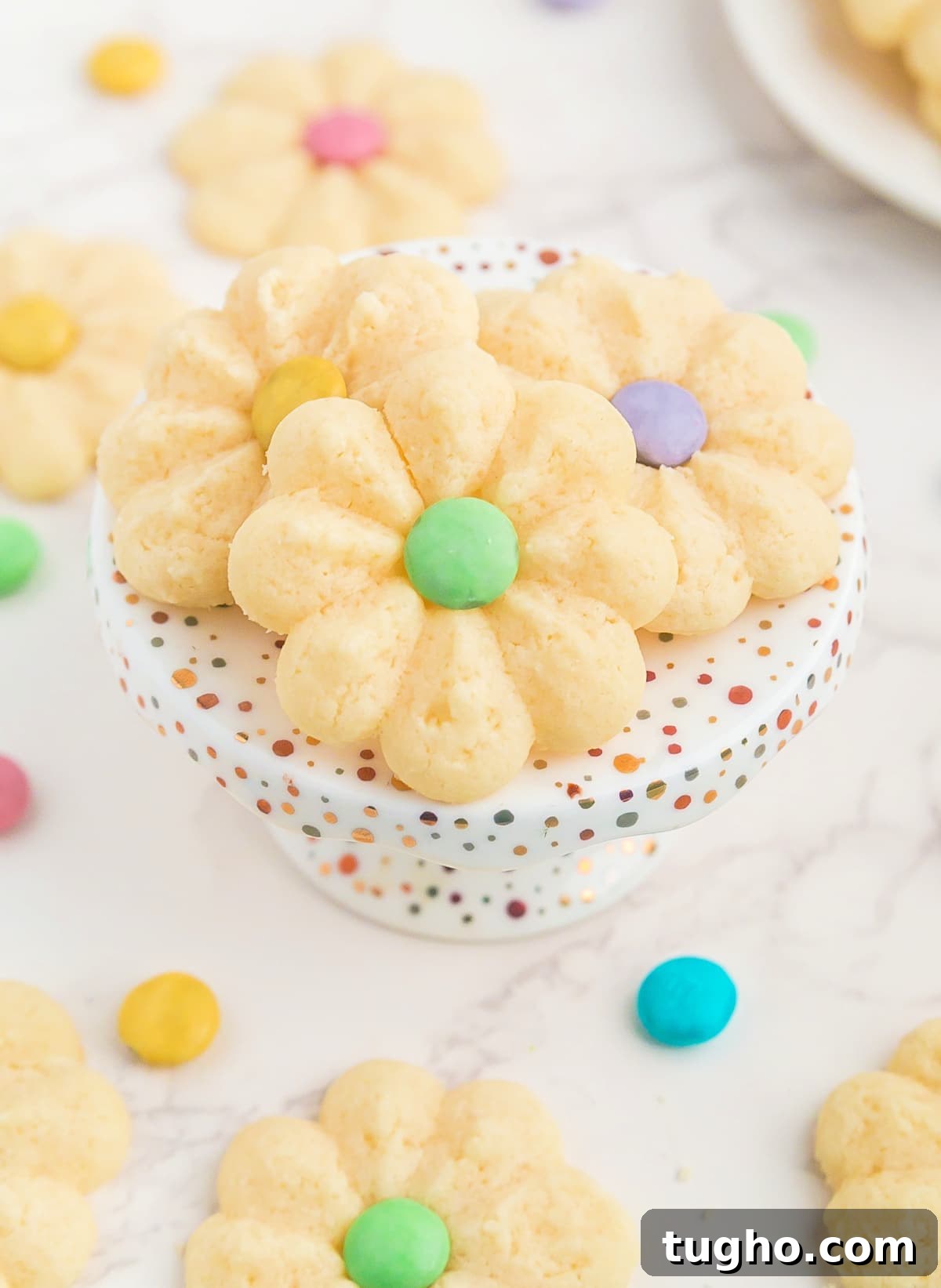 Spring Spritz Cookies are soft, buttery shortbread cookies. You only need 5 ingredients (plus M&Ms) to make these simple flower cookies that are perfect for Spring! 