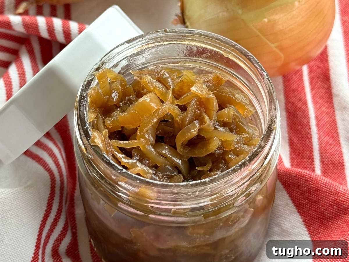 15 Make-Ahead Thanksgiving Recipes to Prep Now 14 Caramelized onions in a glass mason jar with white lid resting against the side of the jar.