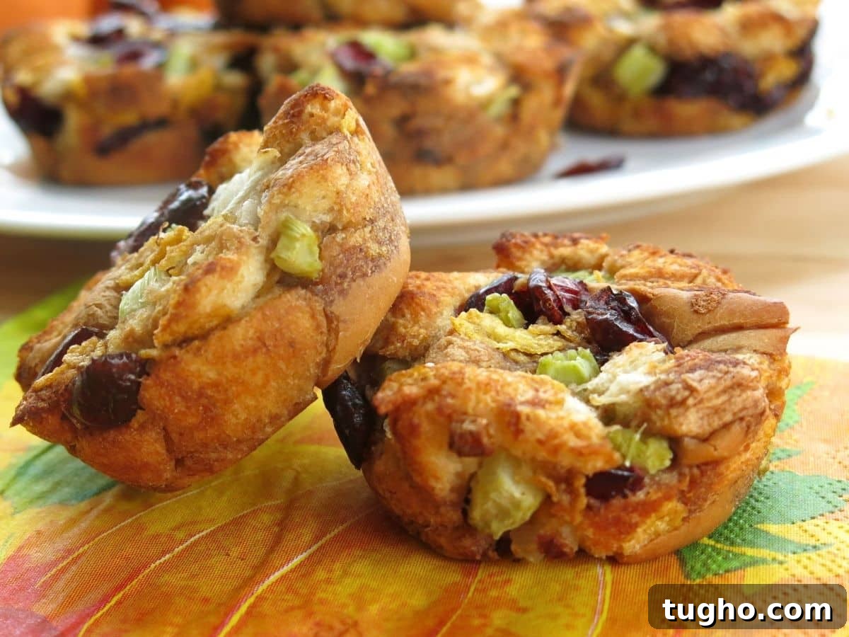 15 Make-Ahead Thanksgiving Recipes to Prep Now 7 Two muffin tin stuffing cups on a fall napkin.