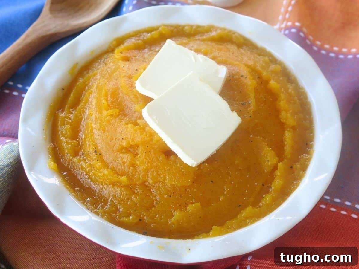 15 Make-Ahead Thanksgiving Recipes to Prep Now 9 Mashed butter nut squash in a white bowl with two pats of butter on top.