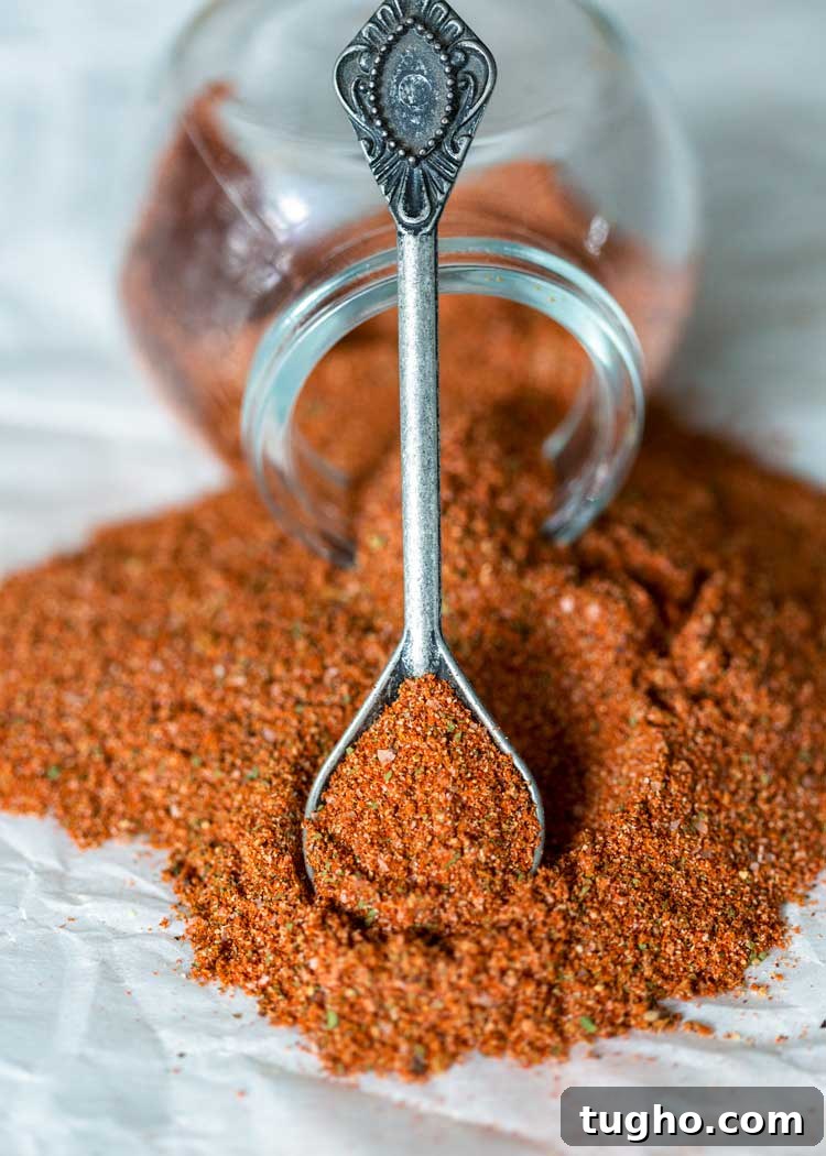 How to Make Authentic Sazon Seasoning 5 jar of spilled sazon and a spoon wth more seasoning blend on it
