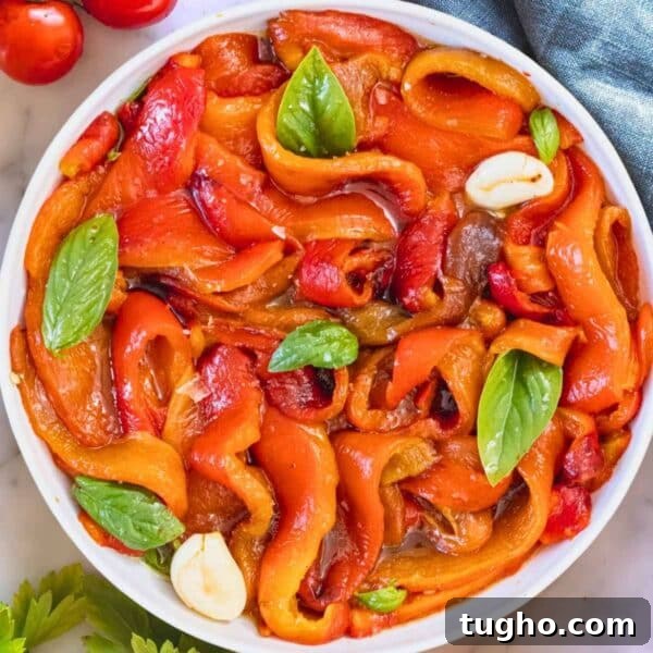 Roasted peppers marinated in a bowl.