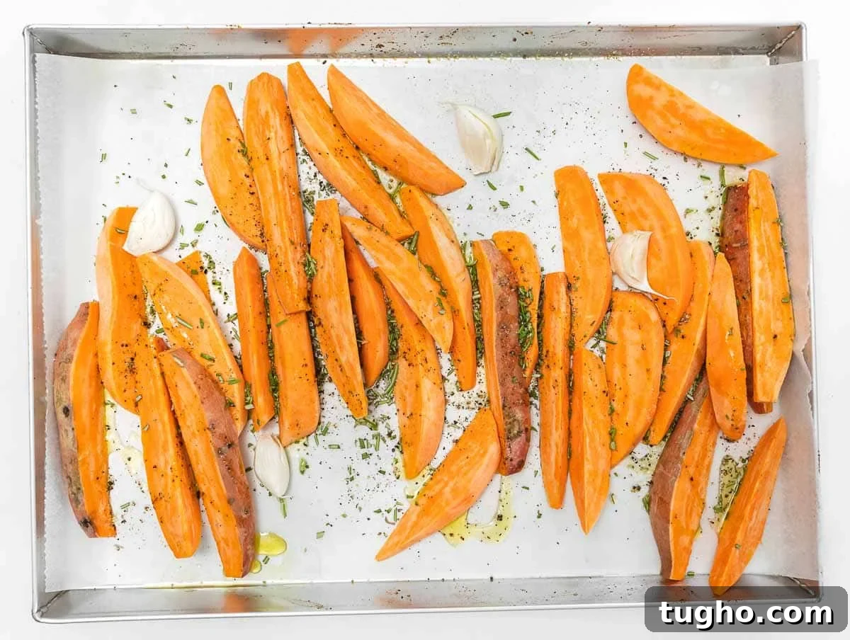 seasoning sweet potato wedges with rosemary, oil, and salt