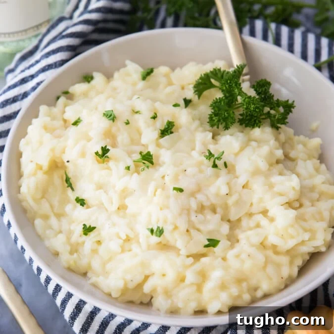 Creamy risotto in a white bowl sprinkled with parsley