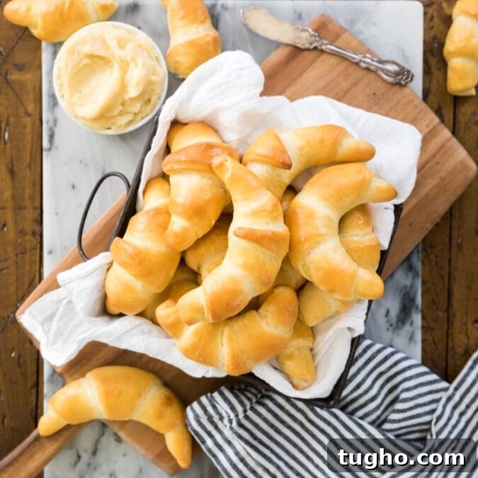 Square dish lined with white towel and filled with crescent rolls
