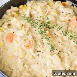 Bowl of turkey chowder topped with fresh thyme and black pepper.