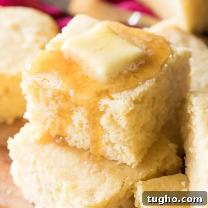 stacked squares of buttermilk cornbread topped with honey and butter