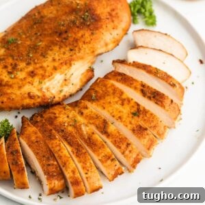 Sliced turkey breast on a white plate.