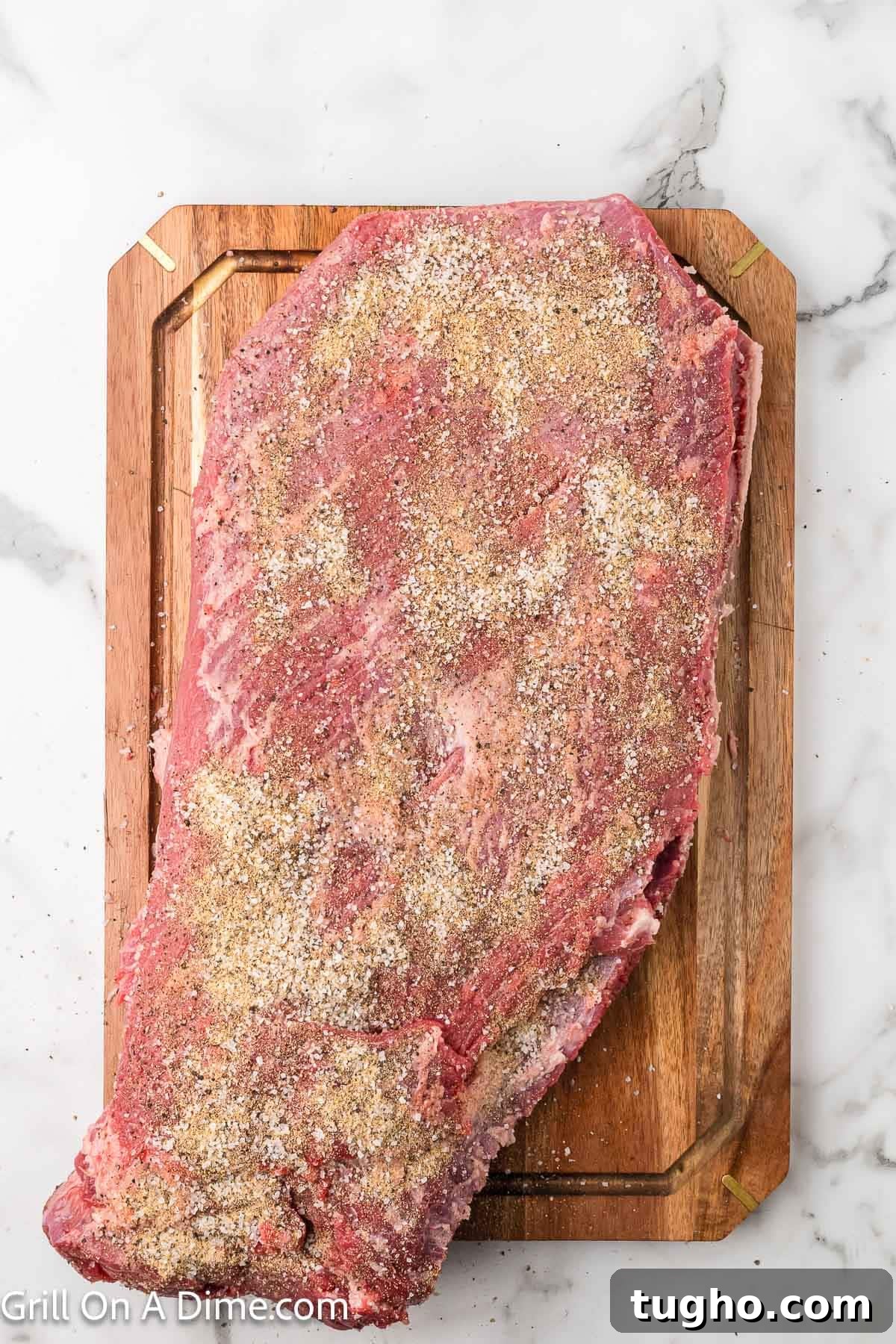 Authentic Texas Style Brisket Recipe 7 Seasoned raw brisket on a cutting board