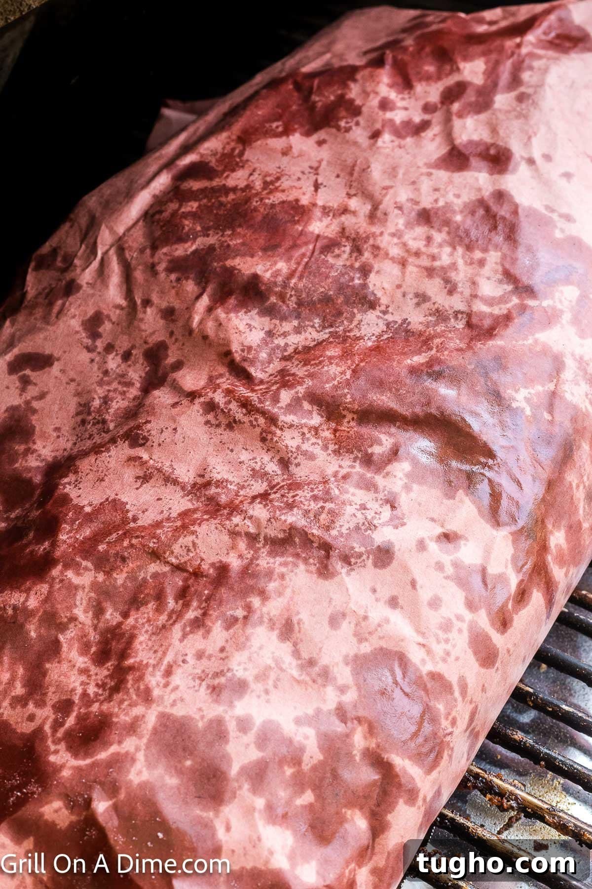 Authentic Texas Style Brisket Recipe 9 Wrapped brisket on the grill grates in the smoker