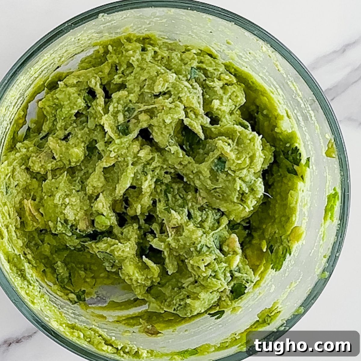 How to Make Authentic Mexican Guacamole with Lime and Cilantro 6 Making the guacamole.