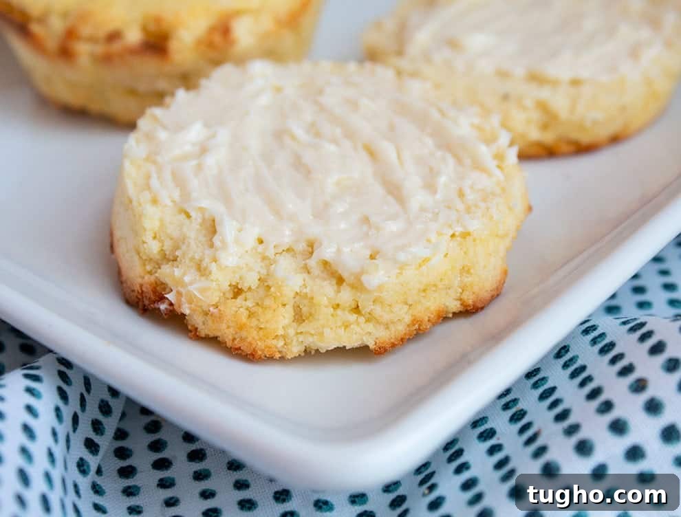 Keto Cornbread Muffins - Low-Carb, Fluffy & Savory 3 closeup of keto cornbread muffins on a white plate cut in half with butter