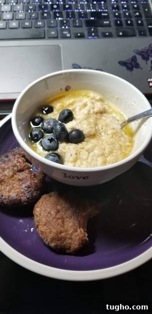 Keto Cornbread Muffins - Low-Carb, Fluffy & Savory 6 keto cornbread muffins made into grits in a bowl with blueberries and maple syrup