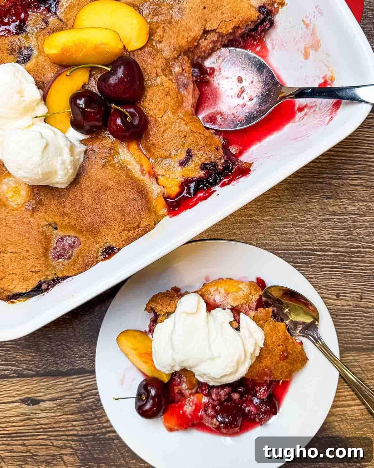 Homemade Cherry and Peach Cobbler Recipe 13 A small plate with a serving of cobbler on it, beside the baking dish.