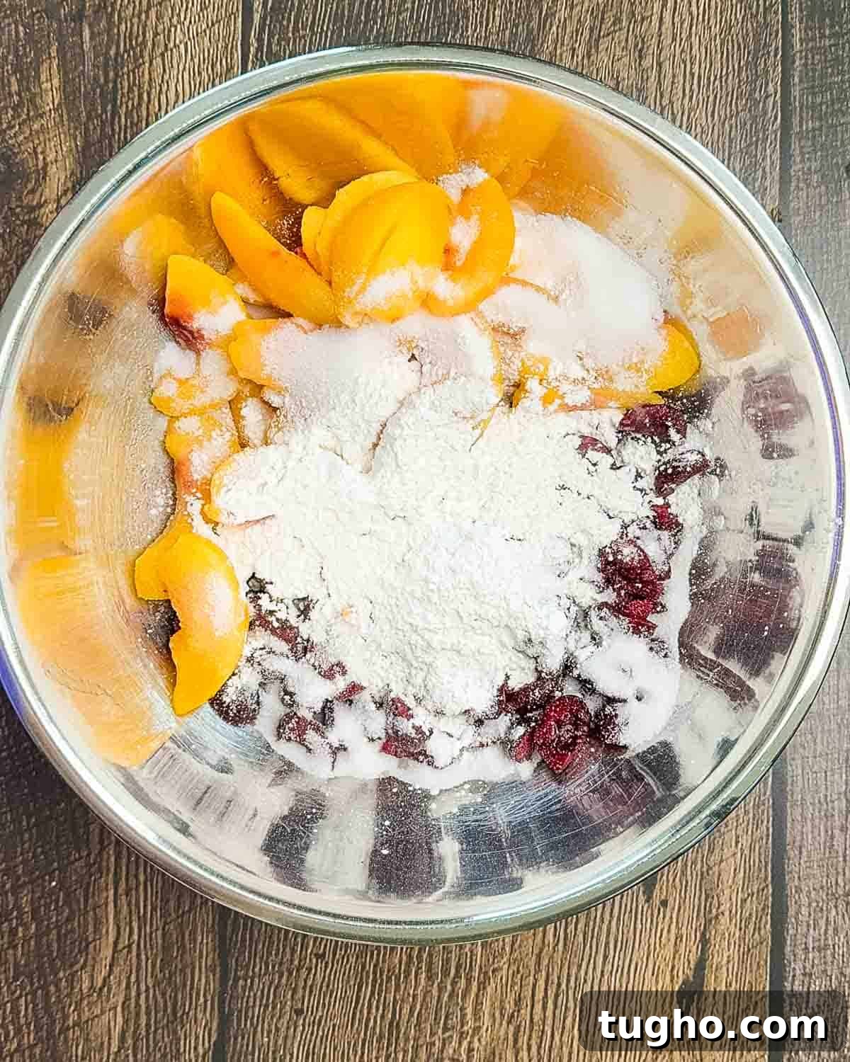 Homemade Cherry and Peach Cobbler Recipe 6 A large bowl filled with cherries, peaches, sugar, lemon juice, vanilla, and cornstarch.