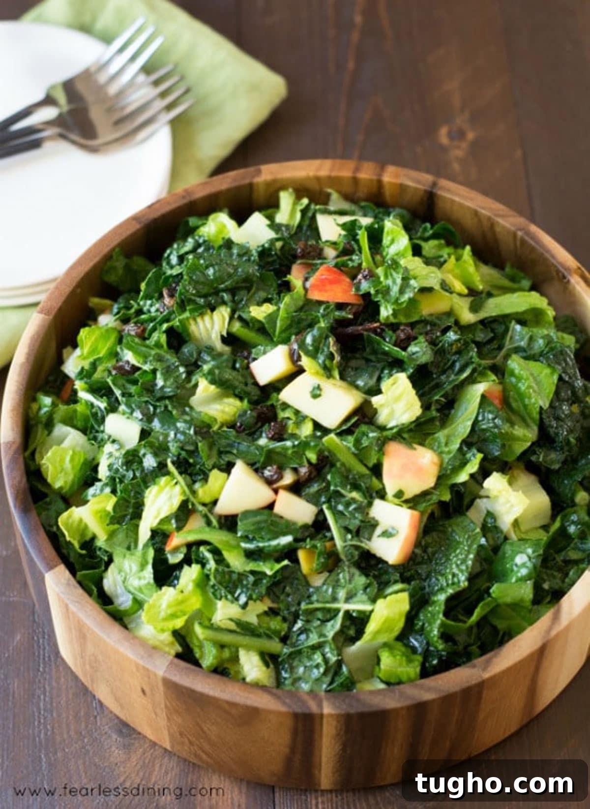 12 Sides That Pair Perfectly with Sloppy Joes 12 A wooden salad serving bowl filled with kale salad.