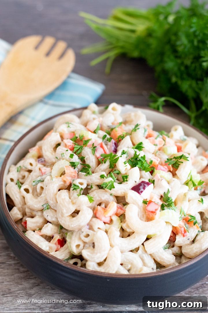12 Sides That Pair Perfectly with Sloppy Joes 13 A big bowl of deli style macaroni salad with a serving spoon and parsley.