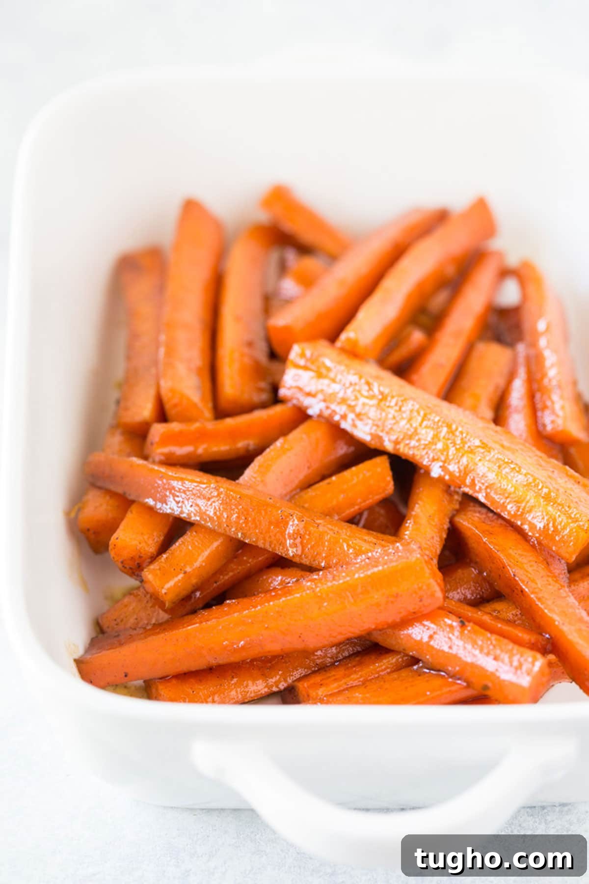 12 Sides That Pair Perfectly with Sloppy Joes 17 A white casserole baking dish full of cooked brown sugar carrots.