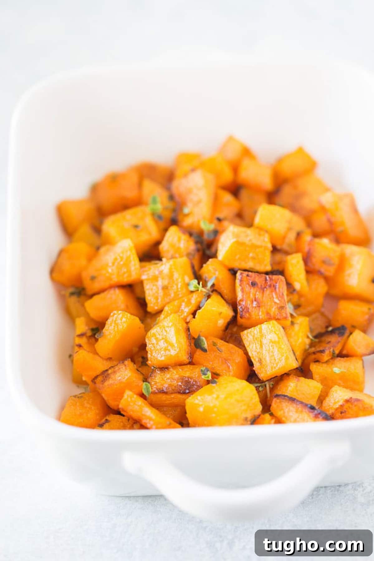 12 Sides That Pair Perfectly with Sloppy Joes 18 A white baking dish with roasted butternut squash.