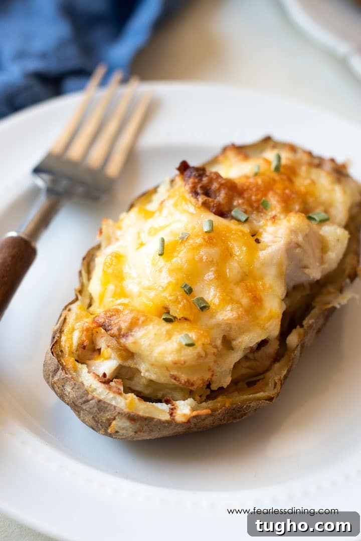 12 Sides That Pair Perfectly with Sloppy Joes 5 A loaded twice baked potato on a plate with a fork