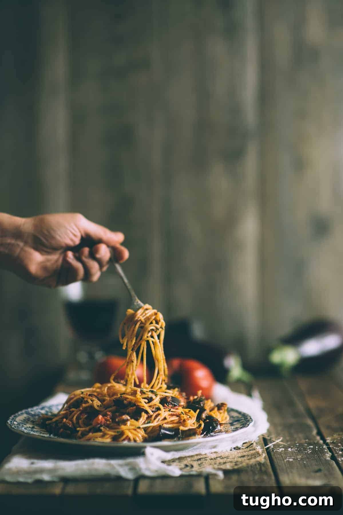 Pasta alla Norma with Eggplant and Ricotta Salata 2 twirling pasta on a fork